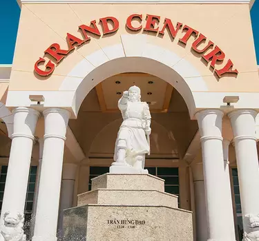 The exterior of the Grand Century Mall and the war general statue and fountain. 