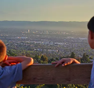two kids overlooking San Jose from a lookout point on a trail in Alum Rock Park