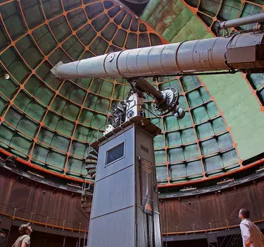 People viewing the giant refractor telescope at Lick Observatory