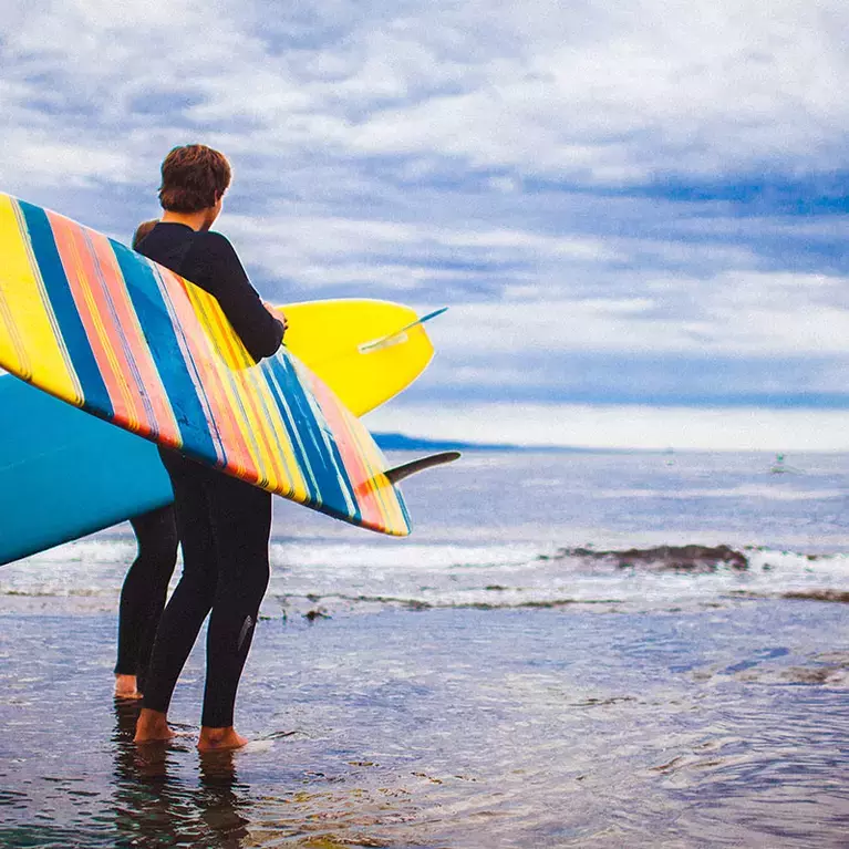 Man Holding Surfboards