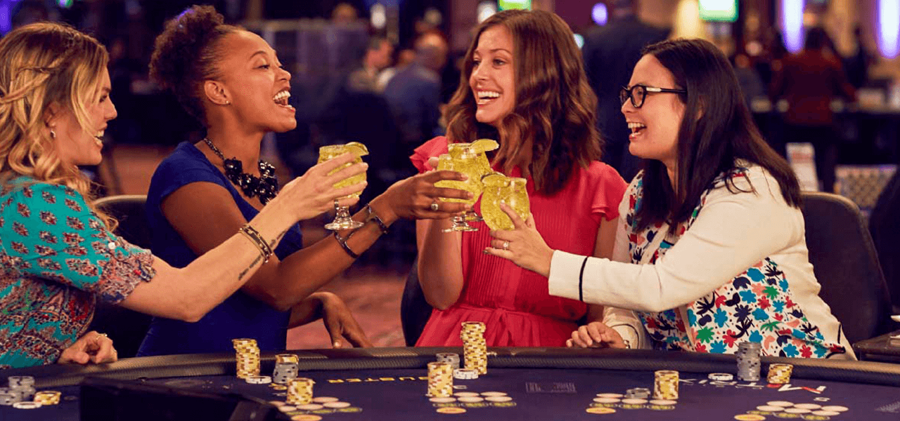 women having a drink at casino m8trix table