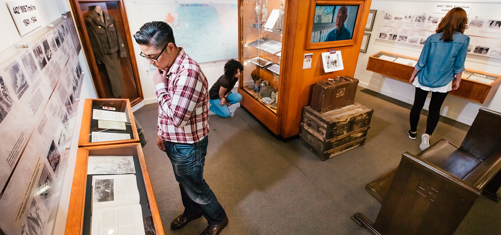 People viewing artifacts on exhibit at the Japanese American Museum in Japantown