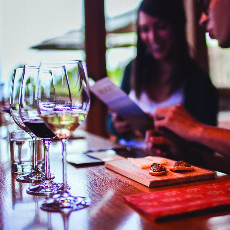 A couple enjoying wine and cheese pairings in the private tasting room at Ridge Winery