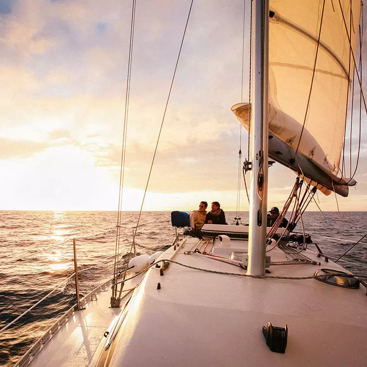 A couple sailing on the Monterey Bay under a gorgeous sunset