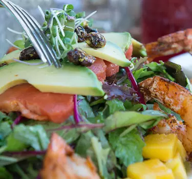 A prawn and avacado salad with housemade flavored lemonades at Zona Rosa.