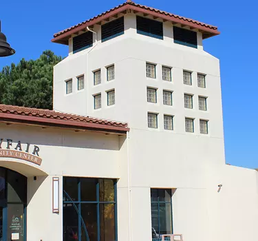 Mayfair Community Center showcasing a Cesar Chavez memorial walkway sign in front of center.