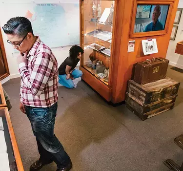 People inside the Japanese American Museum viewing exhibits of Japanese American history