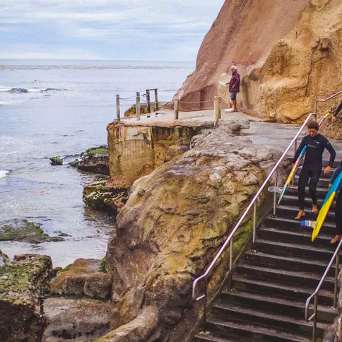 Santa Cruz surfers headed towards the beach