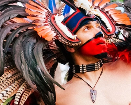 Aztec dancer performs in an Aztec ceremonial dance at the Mexican Herritage Plaza