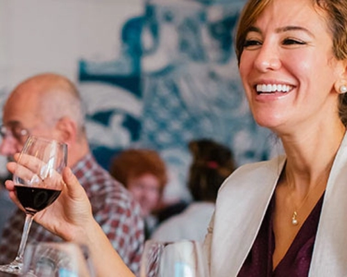 A group enjoying a delicious dinner and wine at Adega restaurant