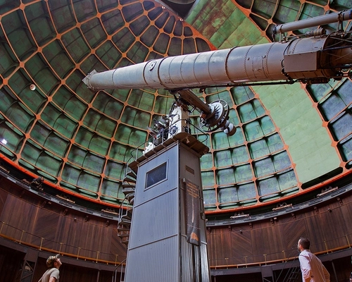 People viewing the giant refractor telescope at Lick Observatory