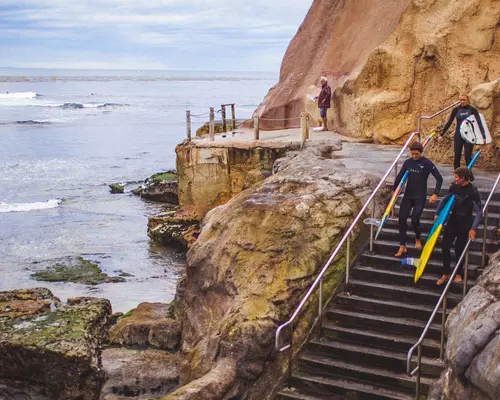 Santa Cruz surfers headed towards the beach