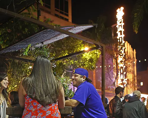 Friend conversing outside of the California Theater 