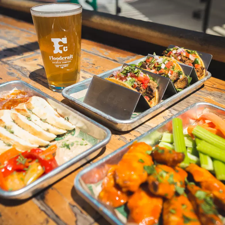 trays of food and glass of beer