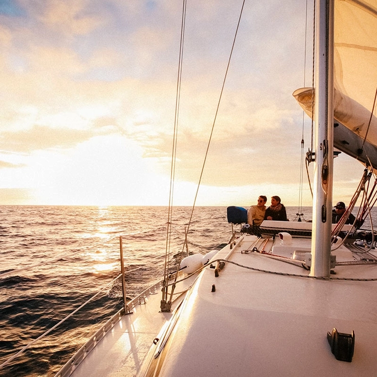 Couple sailing off the shores of Santa Cruz on the Chardonnay sailing charter sailboat