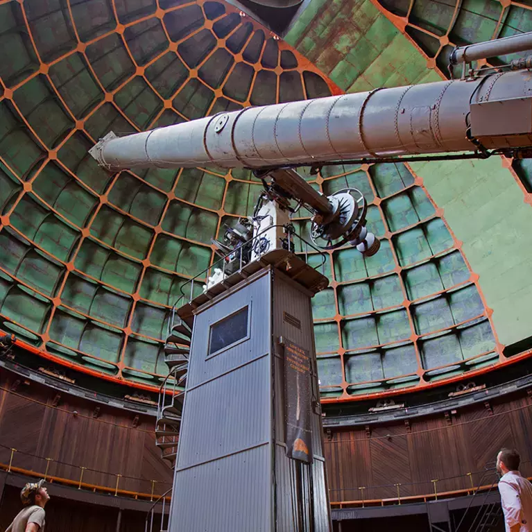 People viewing the giant refractor telescope at Lick Observatory
