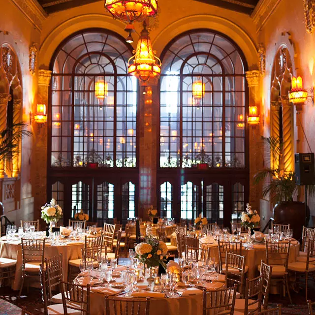The gold embellished lobby of the historic California Theatre set for an elegant sit-down dinner 