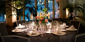 Table set for an elegant sit-down dinner in the grand ballroom of the San Jose Convention Center overlooking the Civic