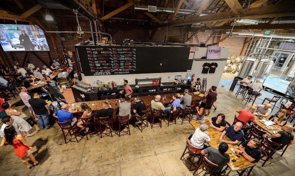 people enjoying food and beer at Uproar Brewery